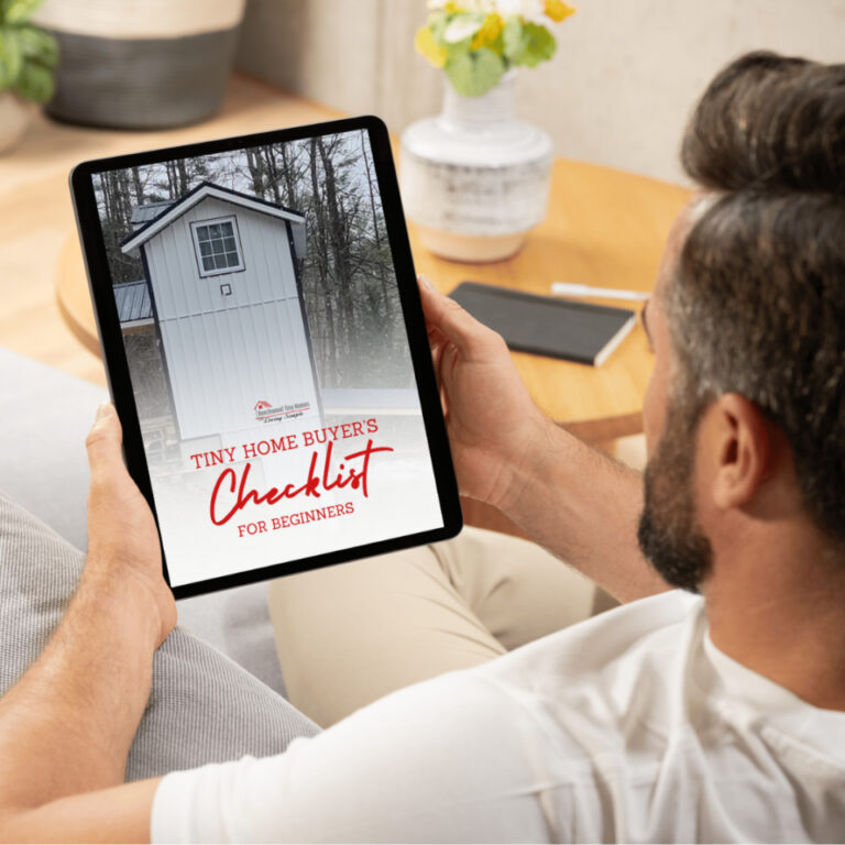 Person holding a tablet displaying the Tiny Home Buyer’s Checklist cover